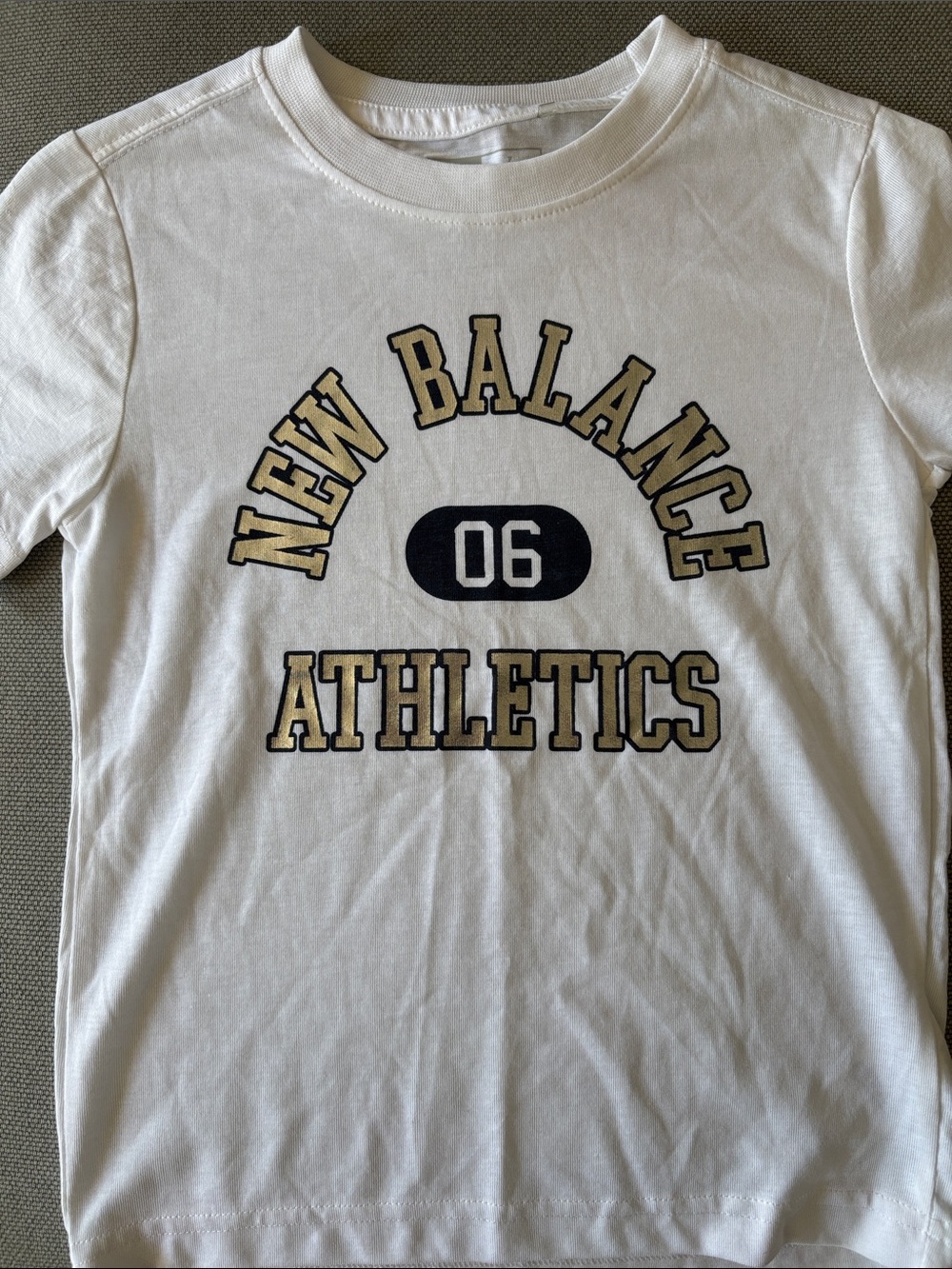 New Balance White Tee with Black and Shiny metallic logo Varsity Graphic